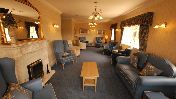 Comfortable lounge area with blue seating and fireplace