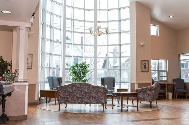 Bright common area with large windows and seating