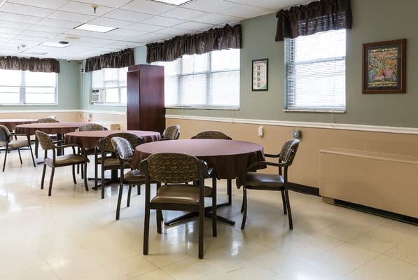 Empty dining area with circular tables and chairs