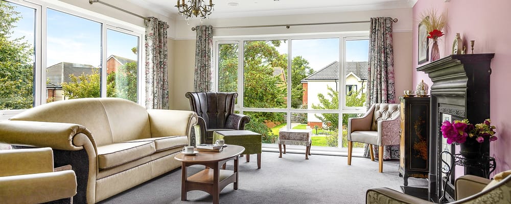 Comfortable common area with large windows and furniture