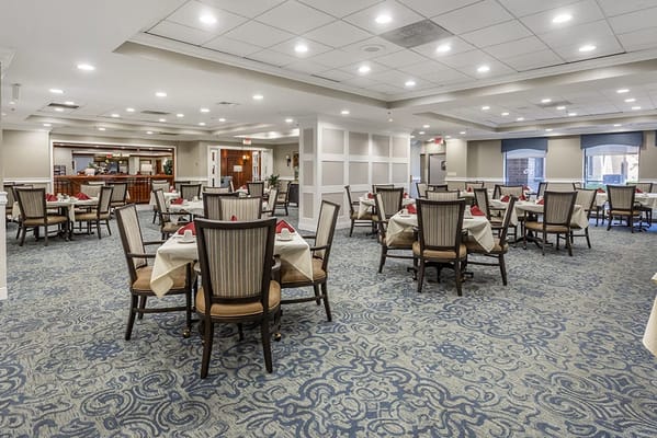Dining area with tables and chairs set for meals