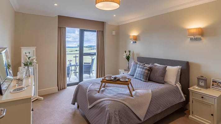 Bright, inviting bedroom with scenic views