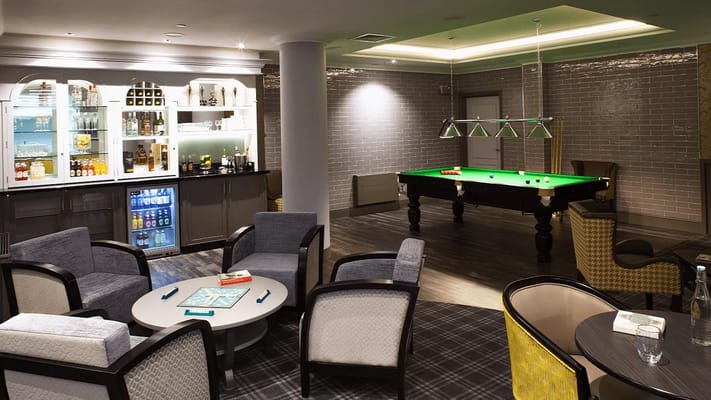 Interior view of a common area with seating and a pool table