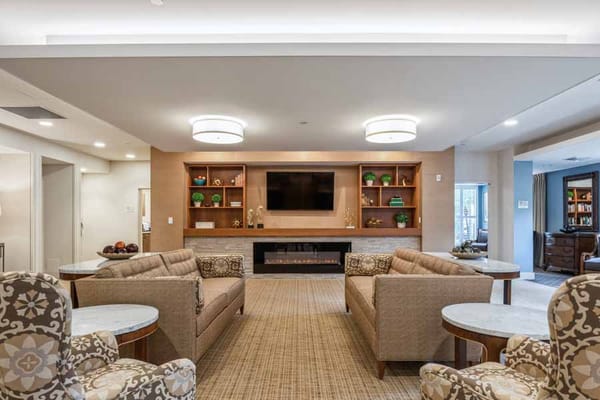 Spacious living room with comfortable seating and television.