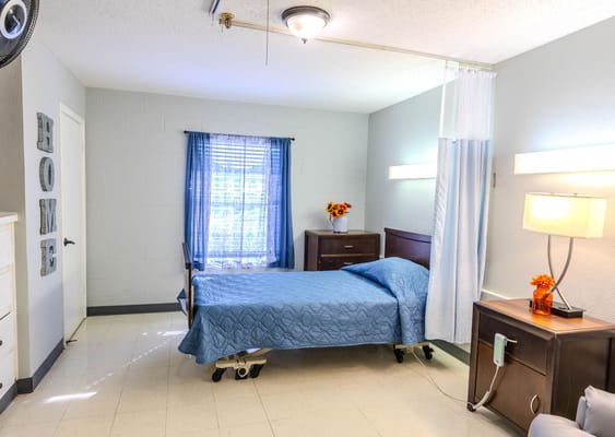 Bright private room with a hospital bed and decor