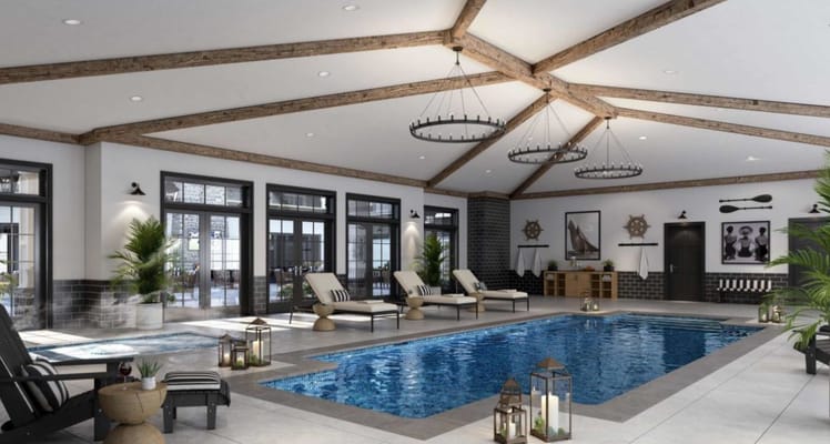 Indoor pool area with lounge chairs and large windows