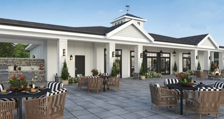 Outdoor dining patio with tables and chairs at The Inn at University Village.