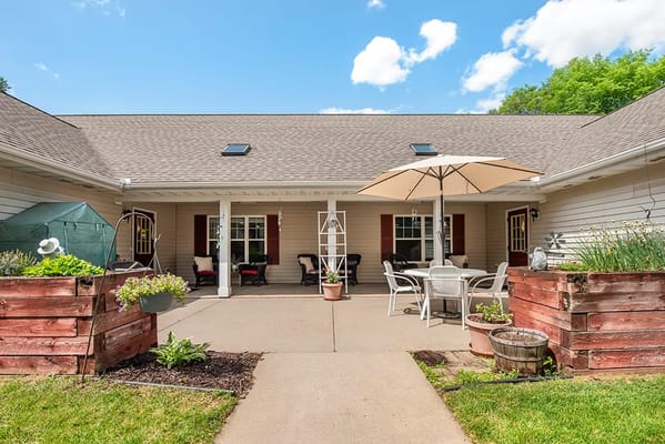 Outdoor seating area with potted plants and umbrellas