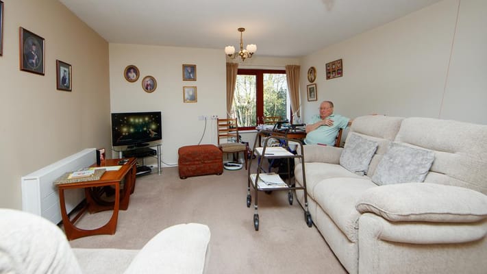 Resident relaxing in a well-furnished living room