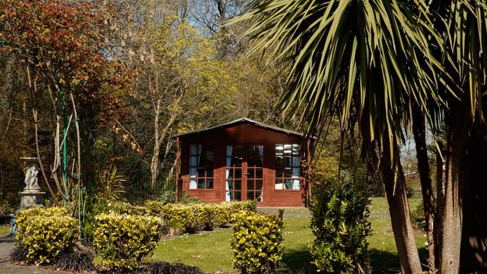 Outdoor space with a wooden building and gardens