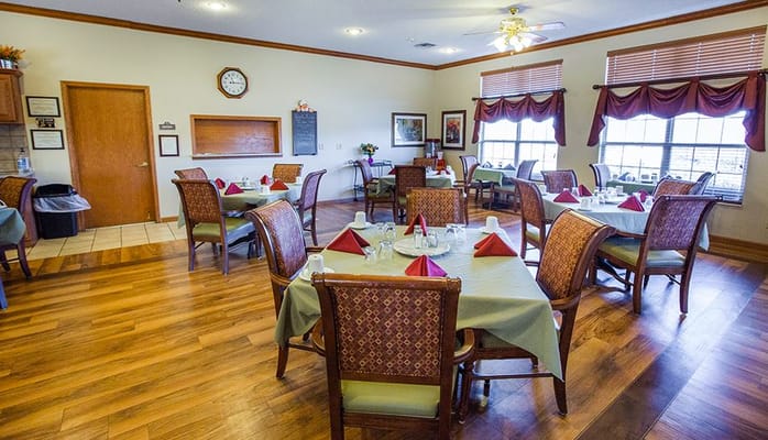 Dining area with neatly set tables and decorations