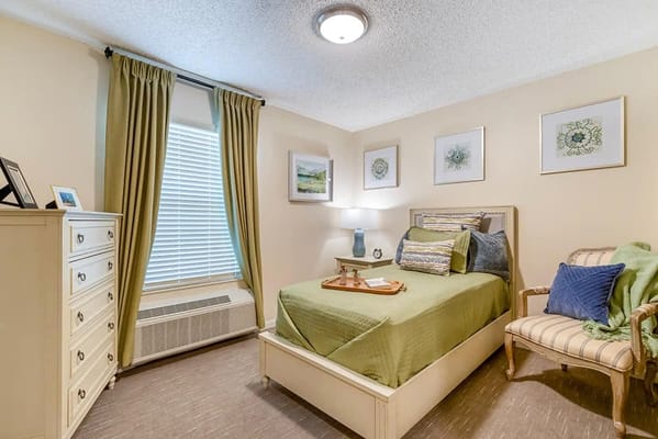 Cozy resident room with a bed and chair