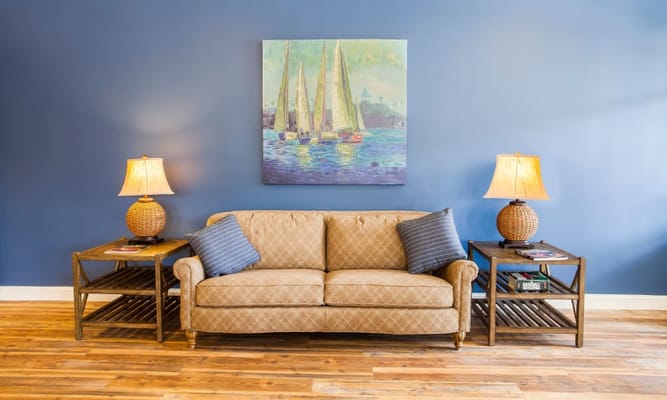 Interior seating area with a couch and lamps