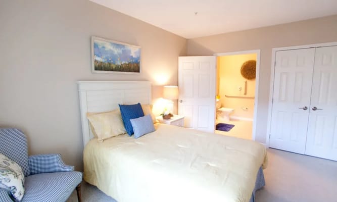 Brightly lit private resident room with a bed