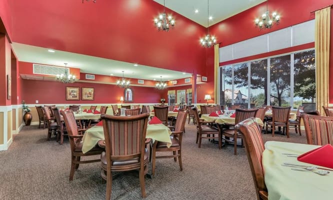 Cozy dining area with red walls and elegantly set tables