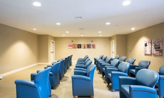 Interior common area with blue chairs and movie theme