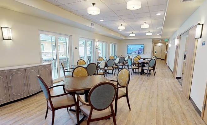 Bright dining area with tables and chairs.