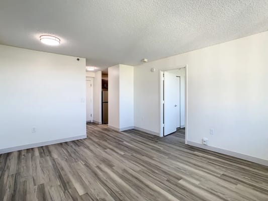 Empty resident room with light wood flooring