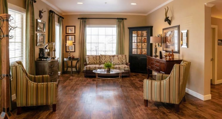 Warm and inviting living room with seating and decorative elements.