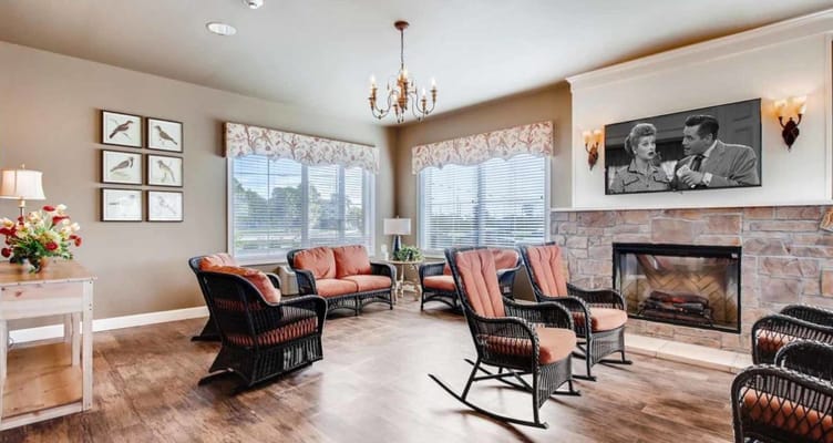 Lounge with seating and a TV in Arbor Hills Memory Care Community