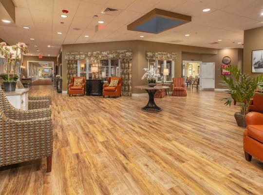 Spacious lobby with comfortable seating and wooden flooring