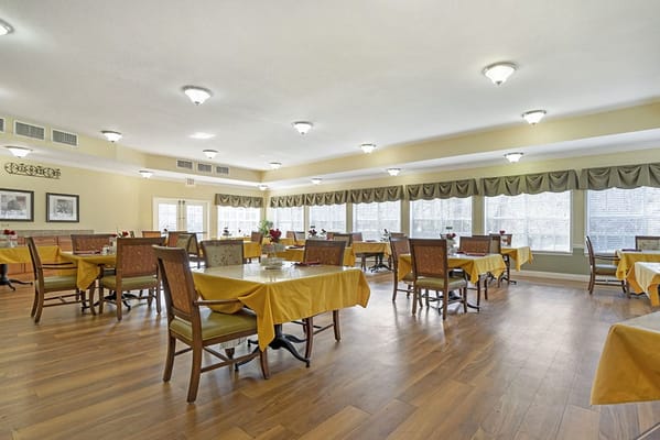 Dining room with tables and chairs set for meals