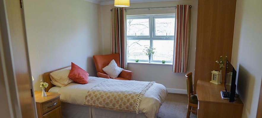 Cozy resident room with a bed and seating area