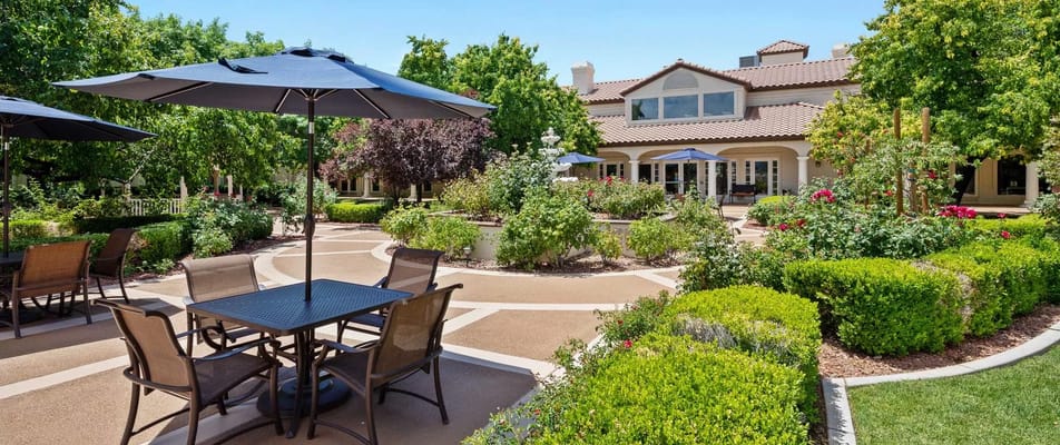 Beautiful landscaped outdoor space with seating and umbrellas