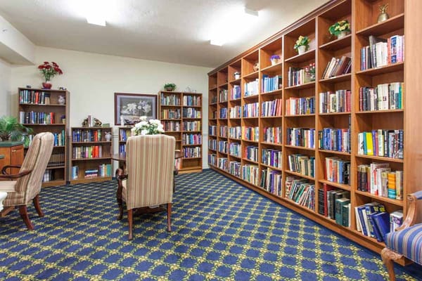 A cozy library with bookshelves and comfortable seating