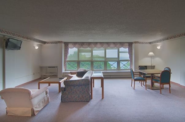 Spacious common area with furniture and large windows