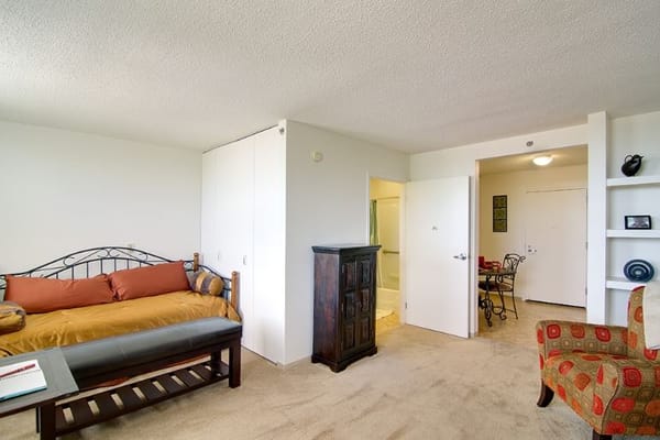 Interior view of a cozy room with a bed and seating area.