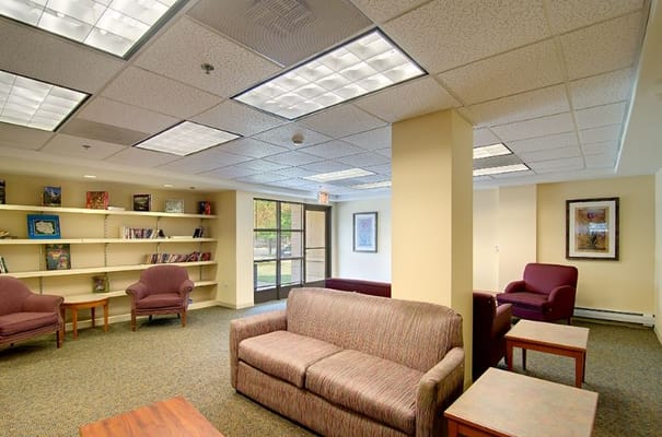A comfortable lounge with seating and bookshelves