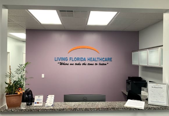 Reception area of Living Florida Healthcare with logo