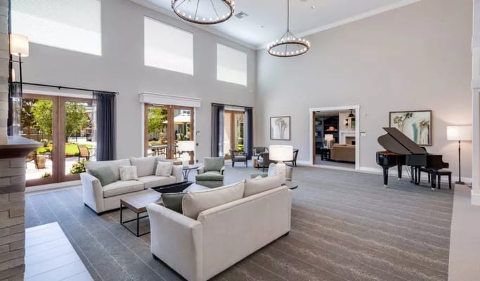 Bright common area with seating and piano