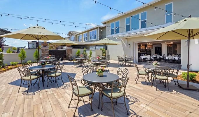 Outdoor patio area with tables and umbrellas
