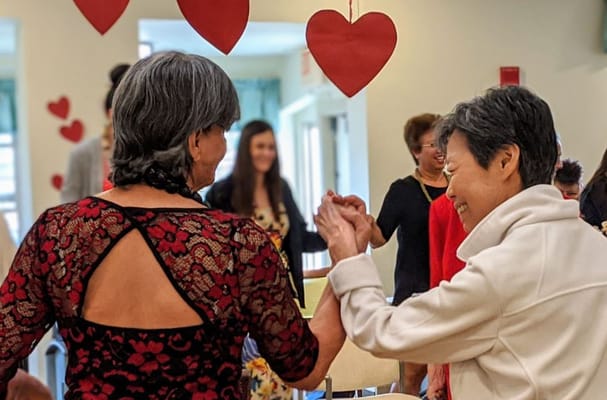 Residents enjoying a dance activity in a common area