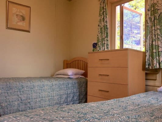 Interior room with two beds and a window