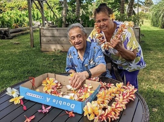 Residents enjoying a flower arranging activity outdoors