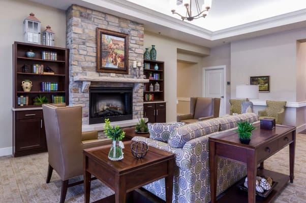 A cozy common area with seating and a fireplace