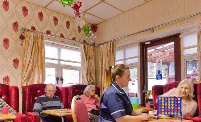 Residents and staff interacting in the lounge area