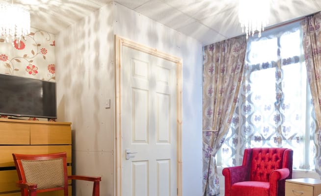 Bright interior space with a red chair and wooden furniture