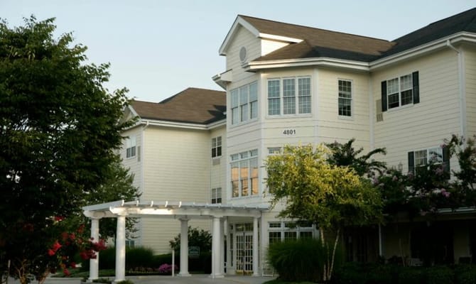 Exterior of Lynridge of Huntsville senior living facility with landscaped entryway.