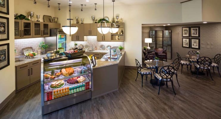 Bright kitchen and dining space with food display and seating