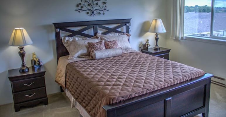Cozy bedroom interior with a bed and lamps