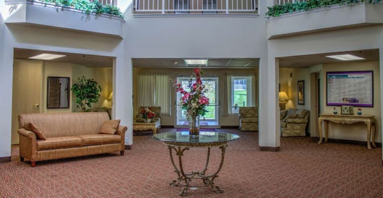 Bright common area with seating and floral arrangement