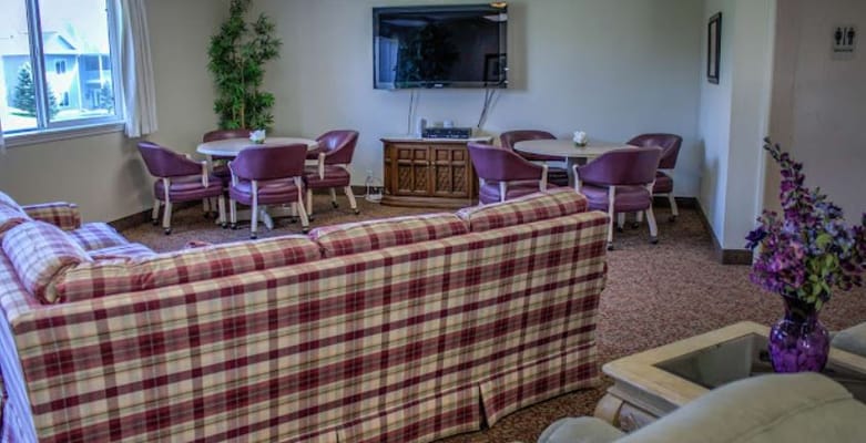 Common area with sofas and tables in a senior living facility