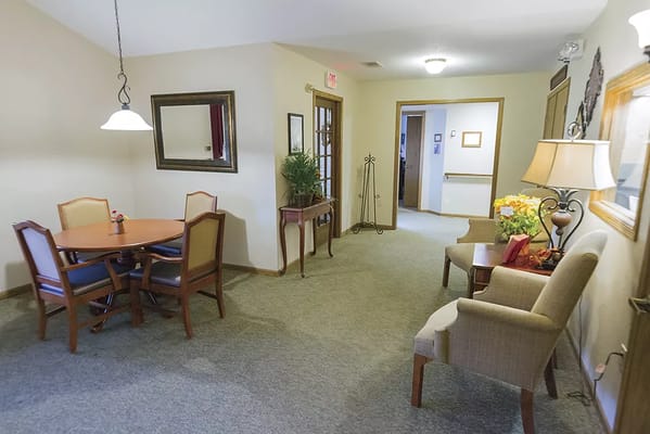 A cozy common area with dining table and chairs
