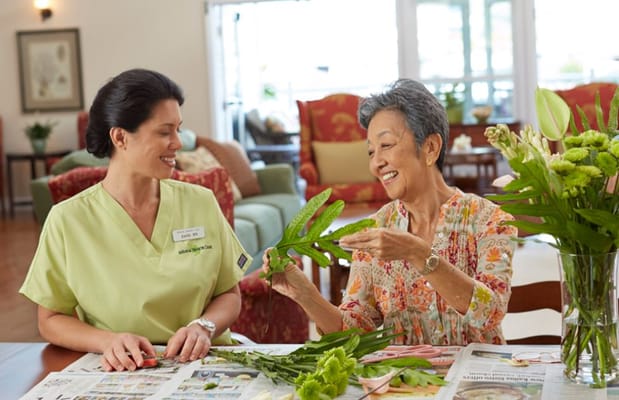 Caregiver and resident engaged in an activity together