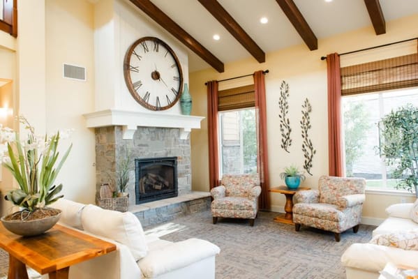 Bright common area with comfortable seating and fireplace