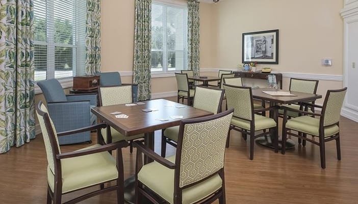 Bright activity room with tables and chairs